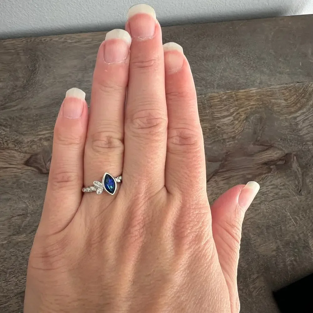 Sapphire blue colored crystal studded elegant ring on silver tone band size 6.25